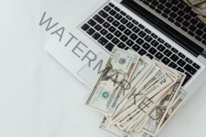 Laptop with money on it showing Revenue Potential